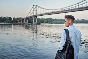 Fototapeta premium Young european man standing on a city street