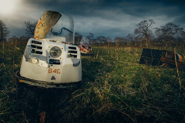 Fototapeta na wymiar old destroyed snowmobile