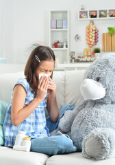 little girl coughing  with toy bear in facial mask