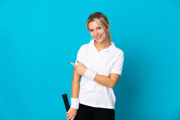 Young Russian woman isolated on blue background playing tennis and pointing to the lateral