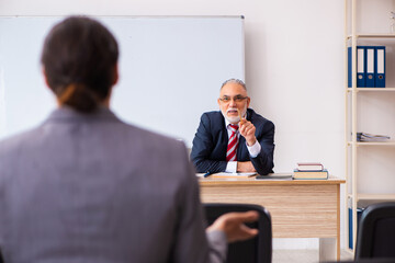 Two businessmen in the classroom in pandemic concept