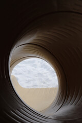 Yellow tunnel slide in the winter at a playground
