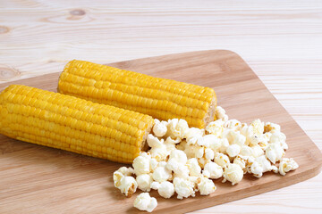 Boiled corn pob and sweet popcorn. Ears of cooked sweet