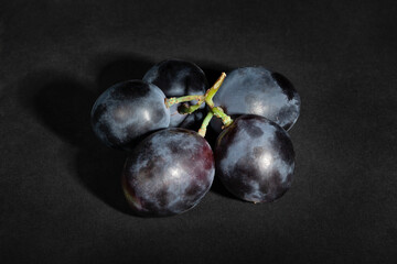 blue grape on black background