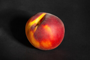 Fototapeta na wymiar one peach on black background