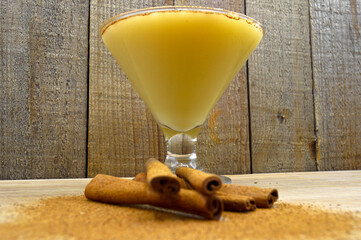 Boza and cinnamon sticks, traditional Turkish cuisine drinks, on wooden background