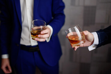 the groom and the best man drink whiskey