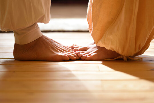 Bare feet of man and woman practicing tantra yoga with a partner