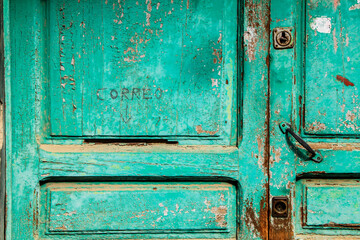 Old wooden door painted green in Spain
