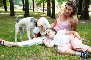 Fototapeta premium young pretty caucasian mother walking with little cute daughter and dog fox terrier, lifestyle people concept