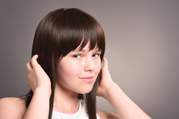 Cute happy girl with dark hair posing