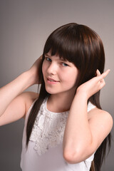 Fototapeta premium Cute happy girl with dark hair posing