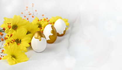 Happy Easter concept with golden decorated eggs, flowers on white silk fabric background. Luxury holiday composition for greeting card or sale. Banner. Copyspace.