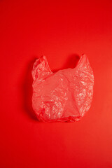 Red plastic bag placed on surface in studio