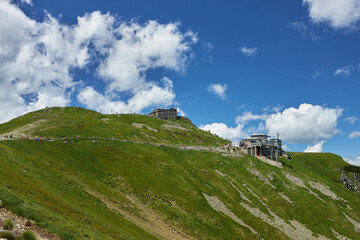 Scenic panoramic view of mountains landscape with blooming meadows