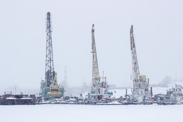 Obraz premium cranes in the port during a snowfall