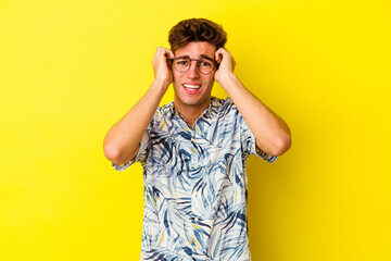 Young caucasian man isolated on yellow background crying, unhappy with something, agony and confusion concept.