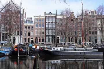 Amsterdam Canal View with Historic House Facades and Boats