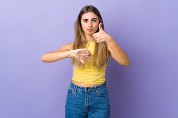 Young woman over isolated purple background making good-bad sign. Undecided between yes or not