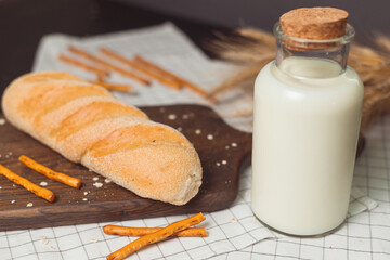 Ciabatta bread with milk bottle and ears of wheat