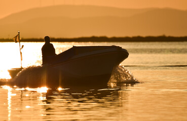 Naklejka na ściany i meble Fishing boat on the sea at sunset