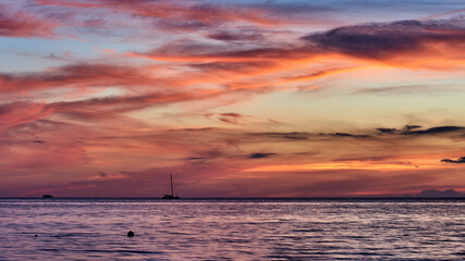 Fototapeta premium Cuba. Trinidad. Sailing boat on a background of purple glow of the sunset