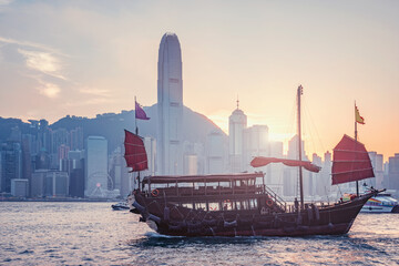 Fototapeta premium Retro ship in Hong Kong harbour at sunset.