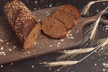 Sliced rye bread on cutting board. Whole grain rye bread with seeds