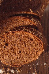 Sliced rye bread on cutting board. Whole grain rye bread with seeds