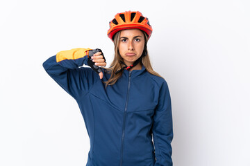 Young hispanic cyclist woman isolated on white background showing thumb down with negative expression