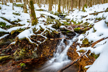 Waterfall on small creek in snowy winter woods, Appalachia, North Carolina