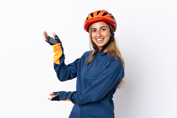 Young hispanic cyclist woman isolated on white background extending hands to the side for inviting to come