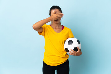 Young hispanic football player woman over isolated on blue background covering eyes by hands. Do not want to see something