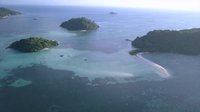drone flight over Saint-Anne Marine Park with white sandbars, blue sea, green islands