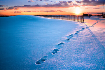 Winter scene under color sky at sunset on snow covered beach. Jones Beach State Park., Long Island NY