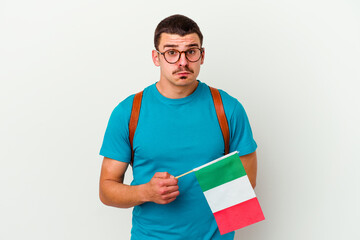 Young caucasian student man holding an italy flag