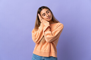 Young hispanic woman over isolated purple background making sleep gesture in dorable expression