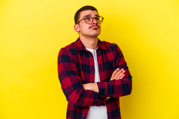 Young caucasian cool man isolated on yellow background tired of a repetitive task.