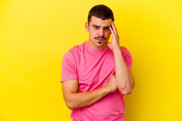 Young caucasian cool man isolated on yellow background blows cheeks, has tired expression. Facial expression concept.