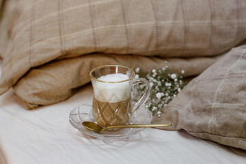 Cappuccino coffee on bed, cozy still life, morning concept, blogger style, warm styled still life