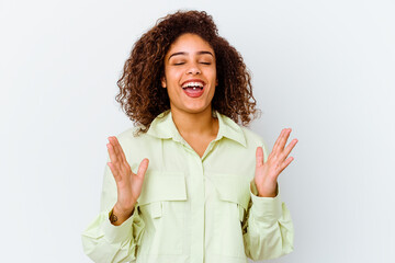 Young african american woman isolated on white background laughs out loudly keeping hand on chest.
