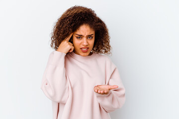 Young african american woman isolated on white background showing a disappointment gesture with...