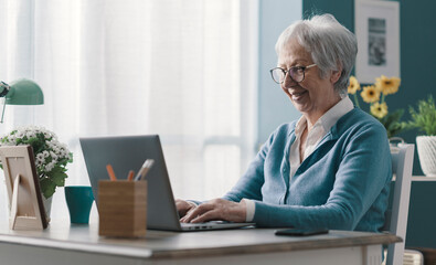 Senior lady using a laptop at home