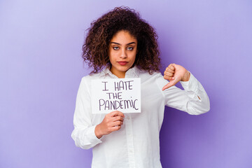 Young African American woman holding I hate pandemic placard isolated on purple background showing...