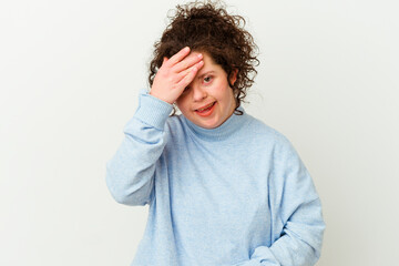 Woman with Down syndrome isolated blink at the camera through fingers, embarrassed covering face.