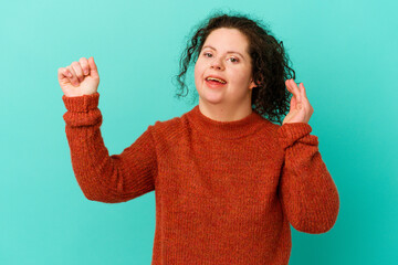 Woman with Down syndrome isolated dancing and having fun.