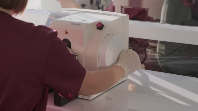 The laboratory assistant makes histological research, microtoming. Rotary Microtome Section for diagnosis in pathology make microscope slide histology. Human tissue equipment.