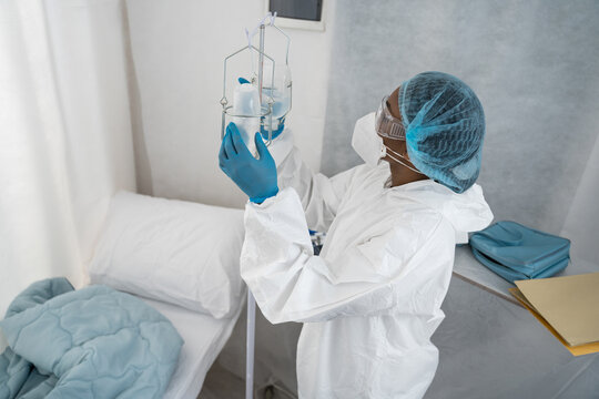 Female doctor adjusting physiological serum dose in a hospital