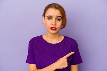 Young arab mixed race woman pointing to the side
