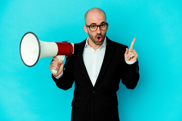 Young business bald man holding a megaphone isolated having an idea, inspiration concept.